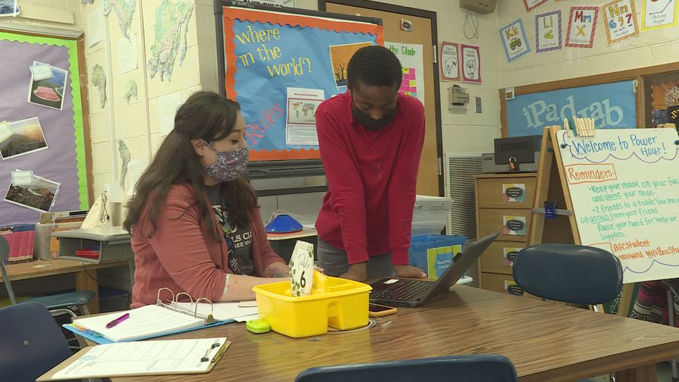 A student works one-on-one with his learning pod teacher
