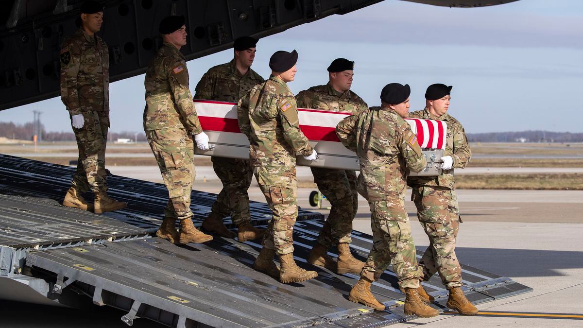 FILE - In this Dec. 25, 2019, file photo, an Army carry team moves a transfer case containing the remains of U.S. Army Sgt. 1st Class Michael Goble, at Dover Air Force Base, Del.. Goble, a U.S. Special Forces soldier who died in Afghanistan this week, was seizing a Taliban weapons cache when he was killed, the U.S. military said Friday. (AP Photo/Alex Brandon, File)