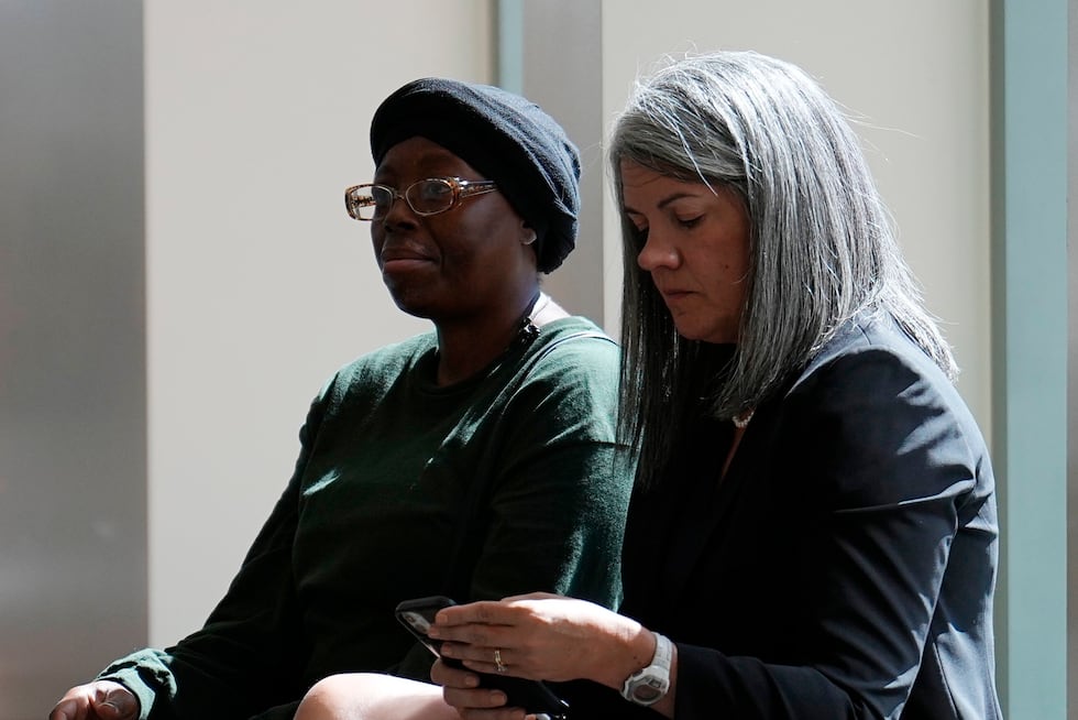 Sheneen McClain, mother of Elijah McClain, sits with Colorado Solicitor General Shannon...