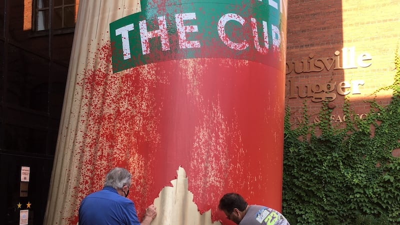 Crews work to clean the Big Bat outside of Louisville Slugger Museum.