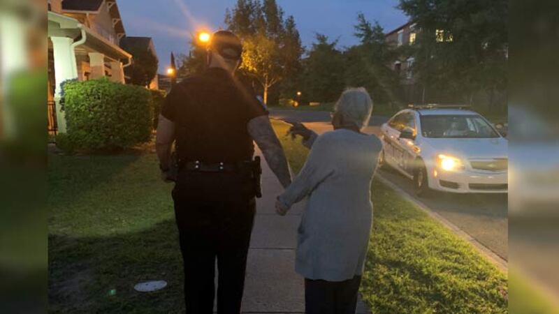 North Charleston Police shared a photo of one of its officers walking with a woman family...