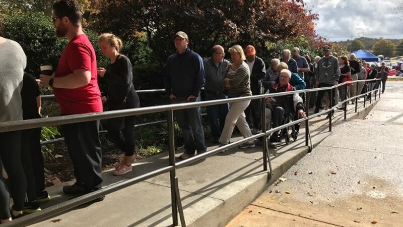 Lines spilled out the door at the Cedar Bluff Schools voting location as dozens of voters wait...