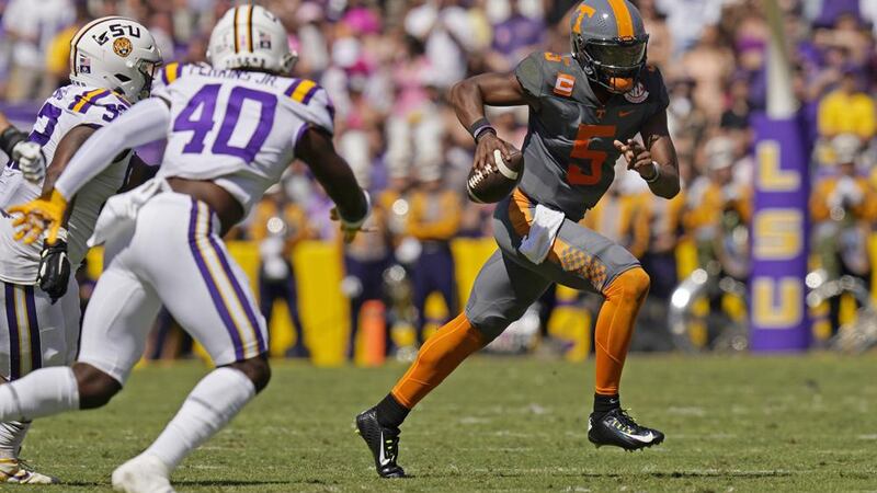 Tennessee quarterback Hendon Hooker (5) carries against LSU linebacker Harold Perkins Jr. (40)...