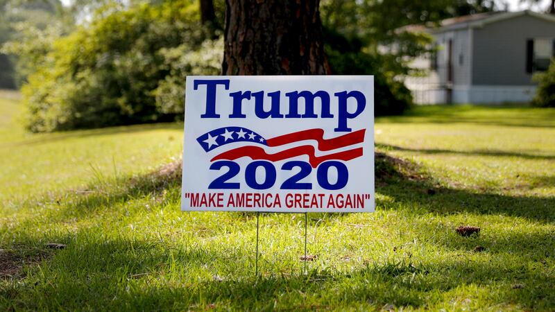 A 2020 presidential campaign sign supporting President Donald Trump sits on a front lawn in...