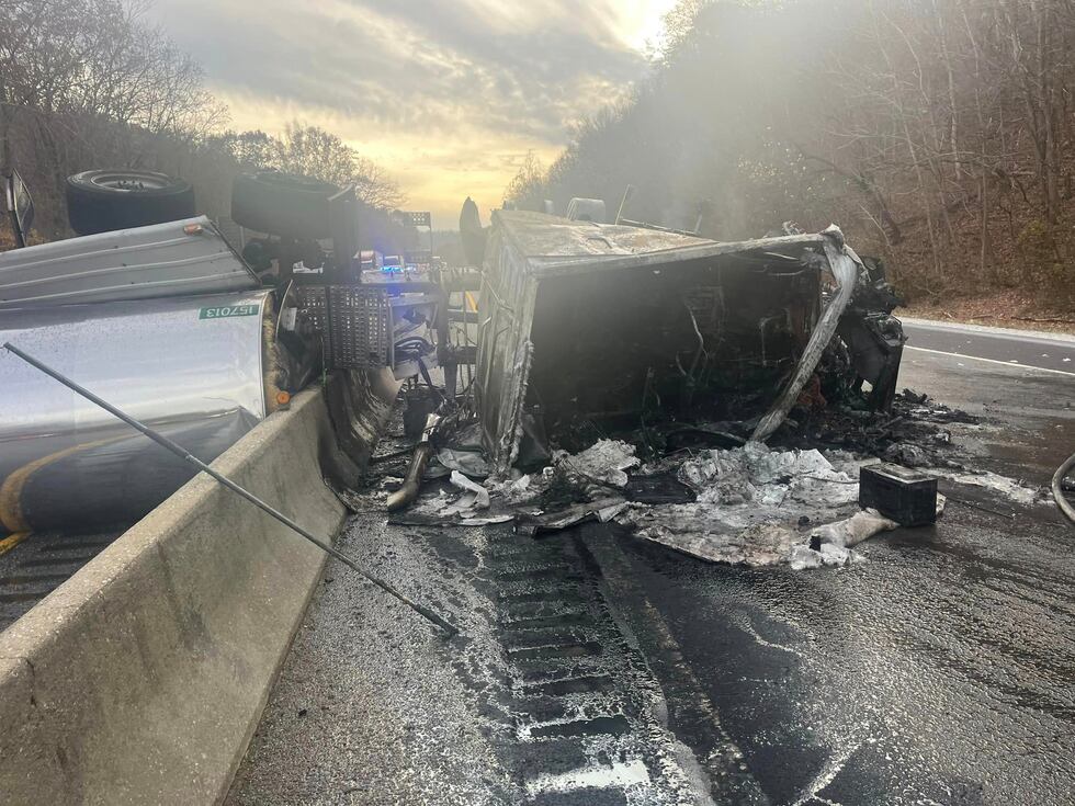 Overturned tractor-trailer hauling maple syrup